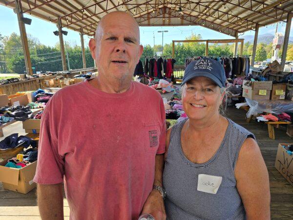 Phil and Jackie, owners of Phil's BBQ Pit in Black Mountain, N.C., together operate a clothing donation hub on Oct. 8, 2024. (Allan Stein/The Epoch Times)