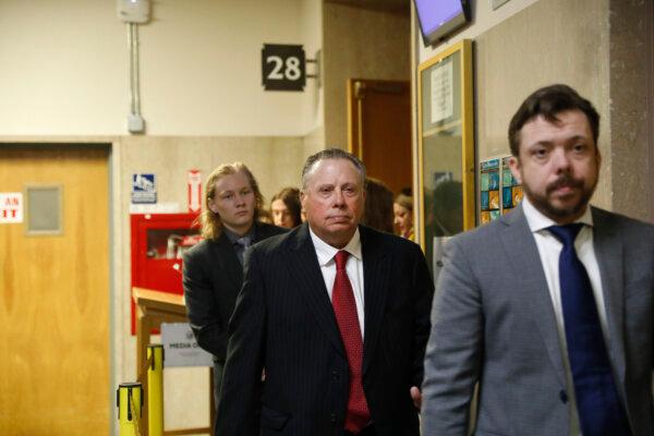 Tim Oliver Lee, (R), brother of Cash App founder Bob Lee; Rick Lee, (C), father of Bob Lee, Krista Lee, and other family members leave Department 28 at the Hall of Justice on the first day of the murder trial of Nima Momeni, in San Francisco on Oct. 14, 2024. (Lea Suzuki/San Francisco Chronicle via AP)