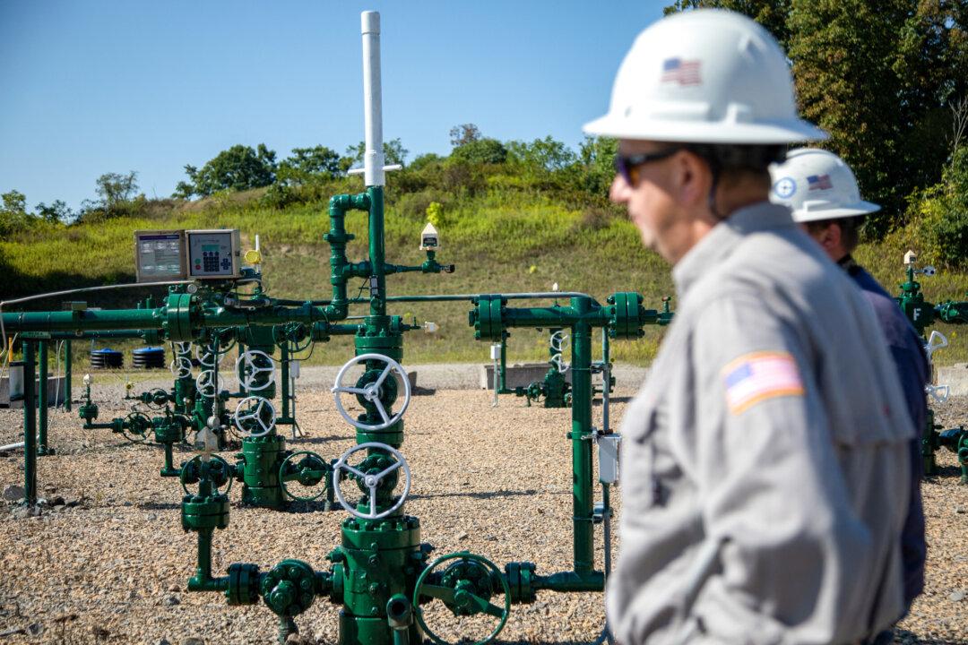 Diversified Energy employees stand by a natural gas well in Franklin Township, Pa., on Sept. 6, 2024. (Rebecca Droke/AFP via Getty Images)