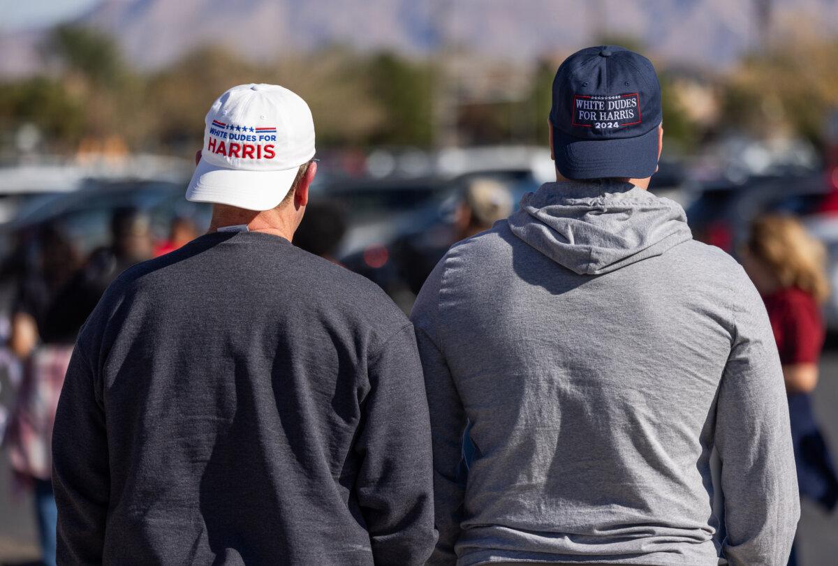 Lance (R) and Jack (L) wait in line to hear former President Barack Obama speak in North Las Vegas, Nev., on Oct. 19, 2024. (John Fredricks/The Epoch Times)