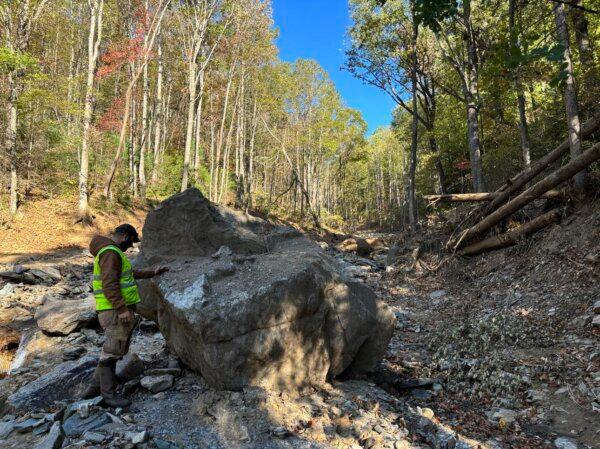 Billy Barthel inspects a property marked for cleanup in the mountains of Little Switzerland, N.C., on Oct. 17, 2024. (Jeff Louderback/The Epoch Times)