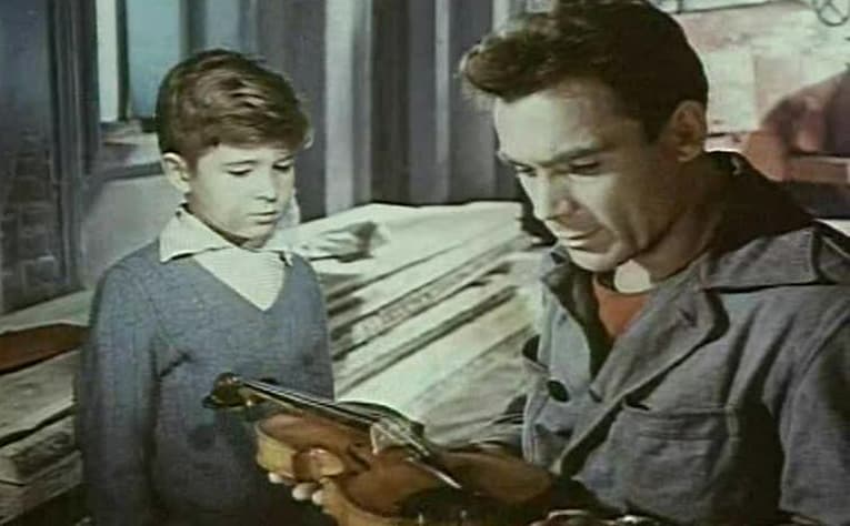 Sasha (Igor Fomchenko, L) gives Sergei (Vladimir Zamanskiy) gives his instrument to examine, in “The Steamroller and the Violin.” (Criterion Collection )