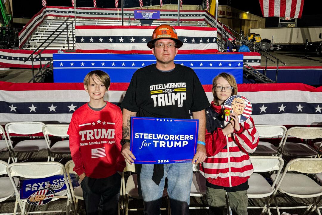 Matthew Kantoris, a unionized steelworker for U.S. Steel in Westmoreland County, and his two children attend a rally held by former President Donald Trump in Latrobe, Pa., on Oct. 19, 2024. (Arjun Singh/The Epoch Times)