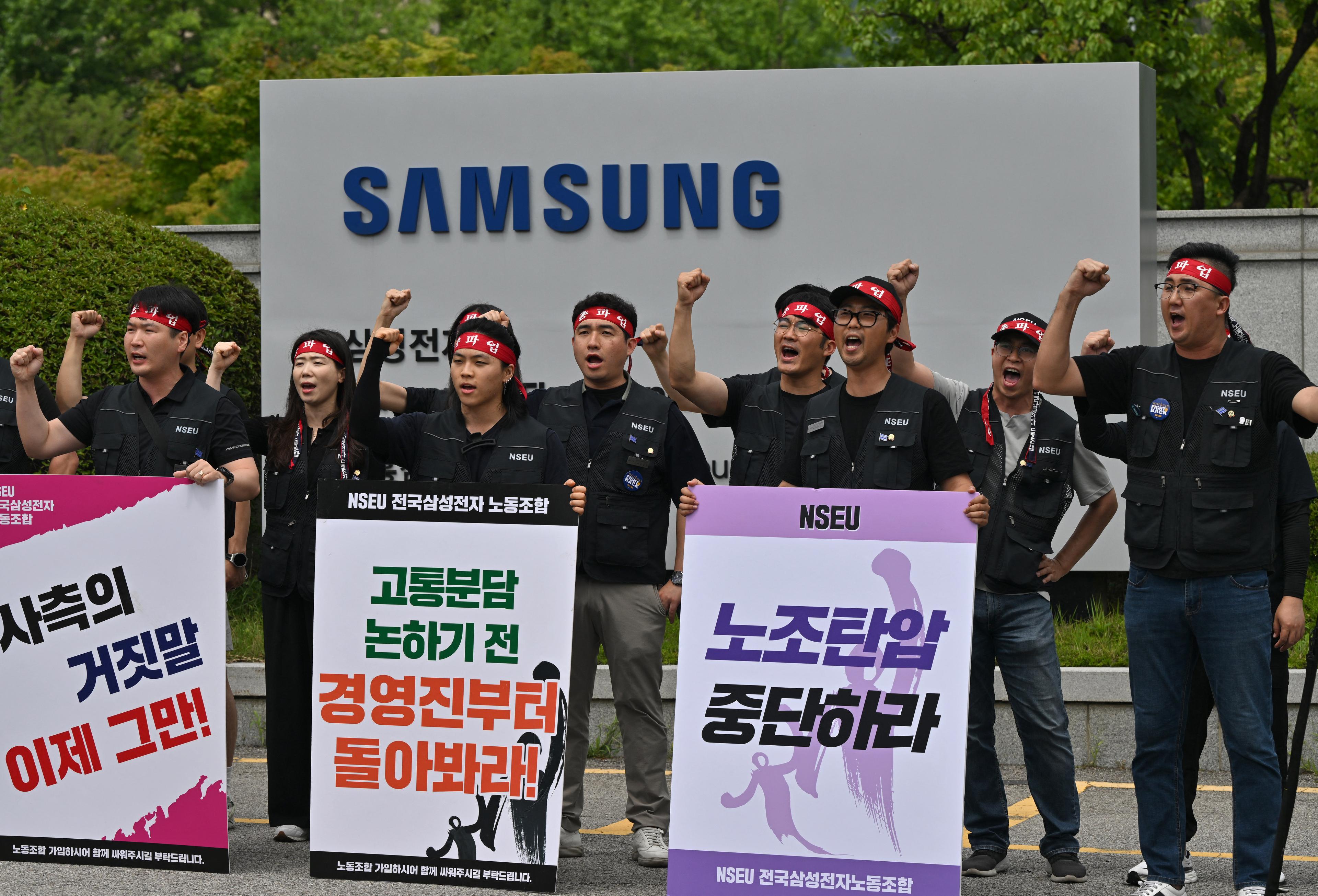 National Samsung Electronics Union members shout slogans in front of a signboard of Samsung Electronics outside the company's Giheung Campus in Yongin, South Korea, on July 10, 2024. (Jung Yeon-je/AFP via Getty Images)