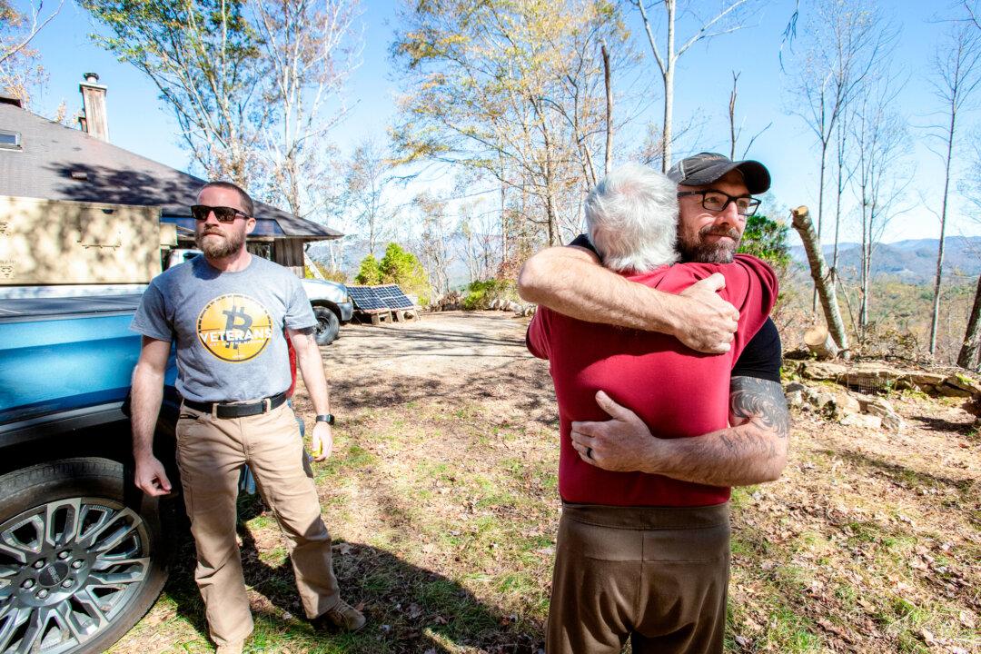 Shane Hazel hugs John Kruppenbach during a visit to his home in North Carolina on Oct. 20, 2024. Hazel and his Bitcoin Veteran organization helped residents in the early aftermath of the storm. (Bobby Sanchez/The Epoch Times)