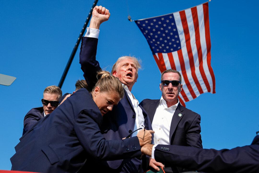 Former President Donald Trump is surrounded by U.S. Secret Service agents after being shot at a campaign rally in Butler, Pa., on July 13, 2024. (Evan Vucci, File/AP Photo)