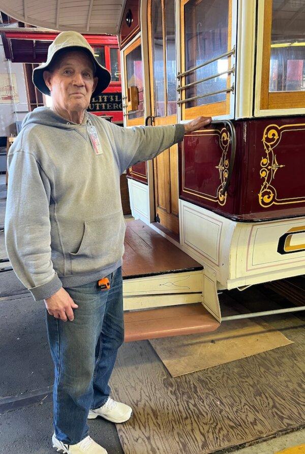 Docent Bob Schneider places his hand on a reconstructed brass handle. (Courtesy of Karen Gough)