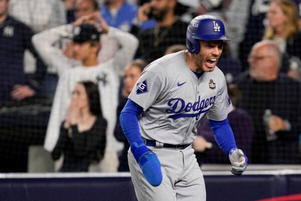 Los Angeles Dodgers' Freddie Freeman celebrates after scoring on a double by Teoscar Hernández during the fifth inning in Game 5 of the baseball World Series, in New York on Oct. 30, 2024. (Ashley Landis/AP Photo)