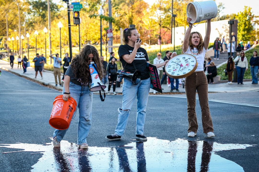 Pro-life supporters pour red paint on the ground during the National Women's March in Washington on Nov. 2, 2024. (Amid Farahi/AFP via Getty Images)