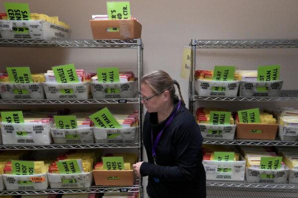 An election worker moves early voting ballots at the Salt Lake County election offices in Salt Lake City, Utah, on Nov. 4, 2024. (Photo by George Frey/AFP via Getty Images)