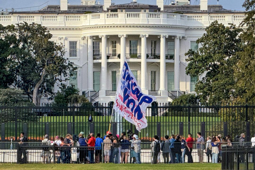 A Trump supporter waves a giant flag outside the White House on Nov. 6, 2024. Former President Donald Trump on Nov. 6 won a sweeping victory in the 2024 presidential election. (Daniel Slim/AFP via Getty Images)