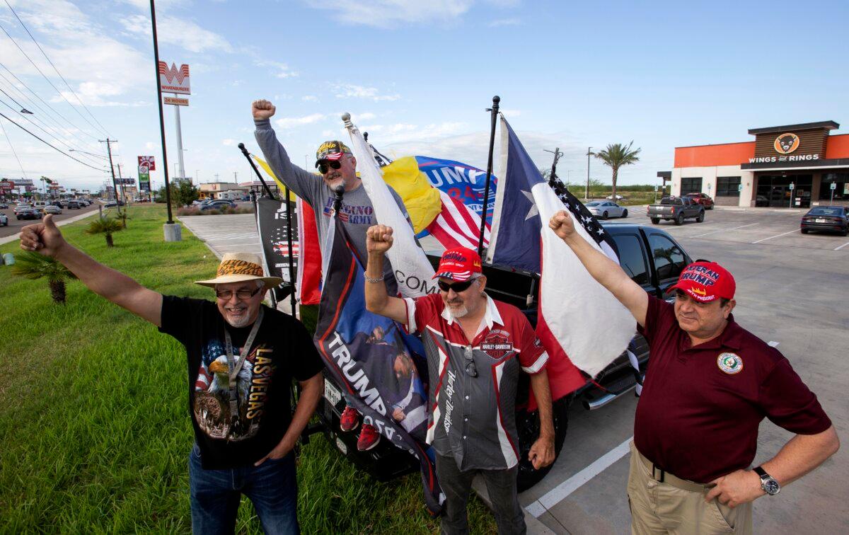 Trump supporters Pat Saenz, Marcus Canales, Roel Reyes, and Ross Barrera wave Trump flags as motorists honk while driving on U.S. 83 in Rio Grande City, Texas, on Nov. 9, 2024. (Bobby Sanchez/The Epoch Times)