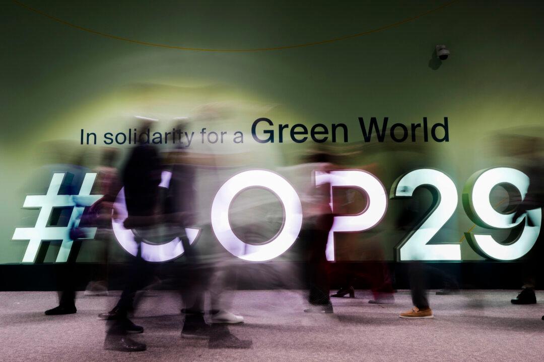 People walk through the COP29 U.N. Climate Summit in Baku, Azerbaijan, on Nov. 13, 2024. (Rafiq Maqbool/AP Photo)