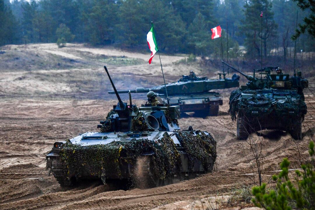 A convoy of Italian and Canadian fighting vehicles and troops take part in the exercise Resolute Warrior of the NATO Multinational Brigade in the Adazi Military Base in Adazi, Latvia, on Nov. 14, 2024. (Gints Ivuskans/AFP via Getty Images)