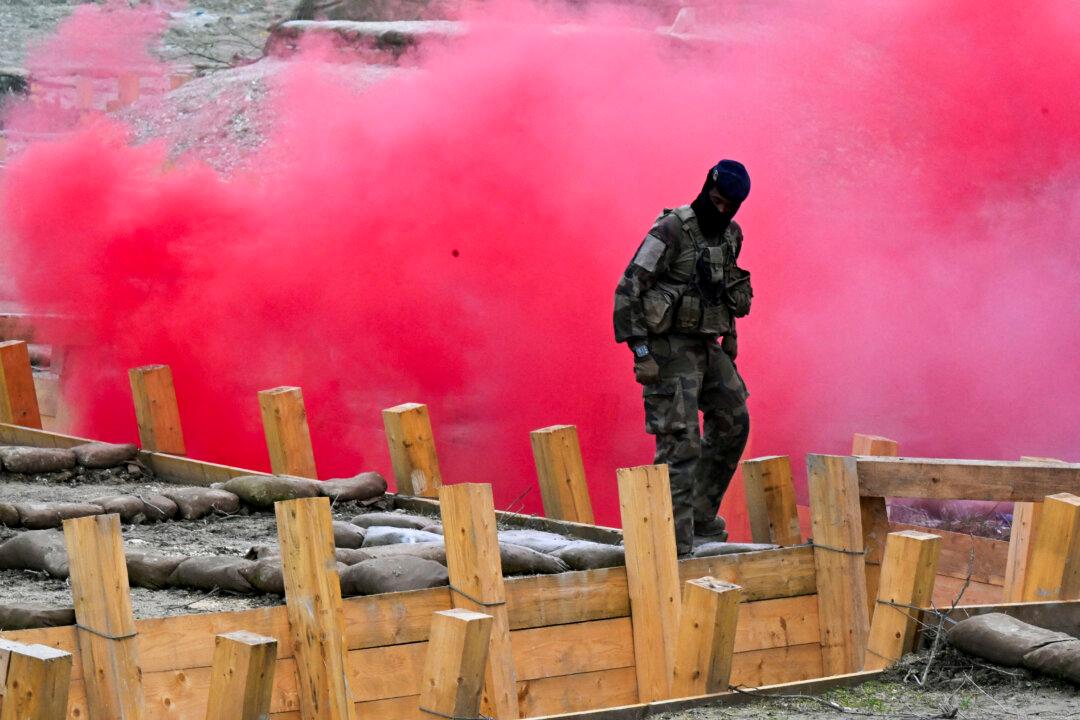 Smoke flares are used as Ukrainian soldiers are trained by the French Army as part of the “Champagne” Task Force, at Mourmelon-le-Grand military camp, in Mourmelon-le-Grand, France, on Nov. 14, 2024. (Francois Nascimbeni/AFP via Getty Images)