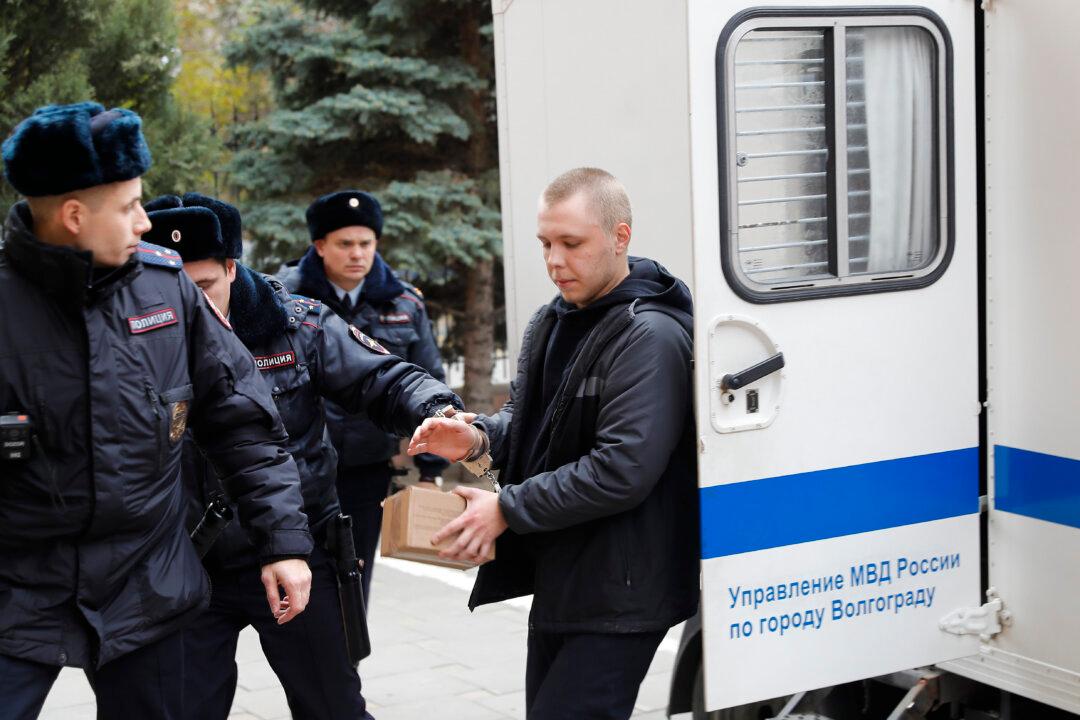 Nikita Zhuravel, is escorted by the police to a court prior to a hearing of a treason case in Volgograd, Russia, on Nov. 14, 2024. (AP Photo)