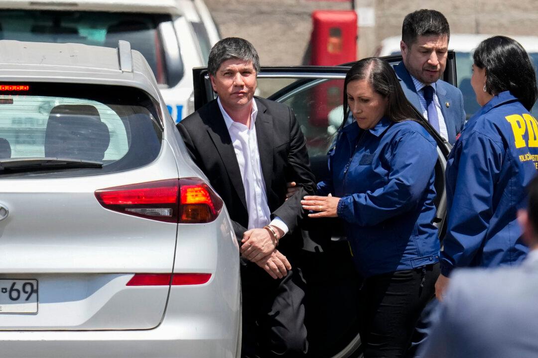 Former Chilean Interior Minister Manuel Monsalve is escorted by an Investigative Police agent after he was arrested as part of an investigation into an alleged rape of a female official that led to his resignation, in Santiago, Chile, on Nov. 14, 2024. (Esteban Felix/AP Photo)