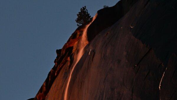Water flowing off Horsetail Fall glows orange while backlit from the setting sun during the "Firefall" phenomenon in Yosemite National Park, California, on Feb. 15, 2023. (Frederic J. Brown/AFP via Getty Images)