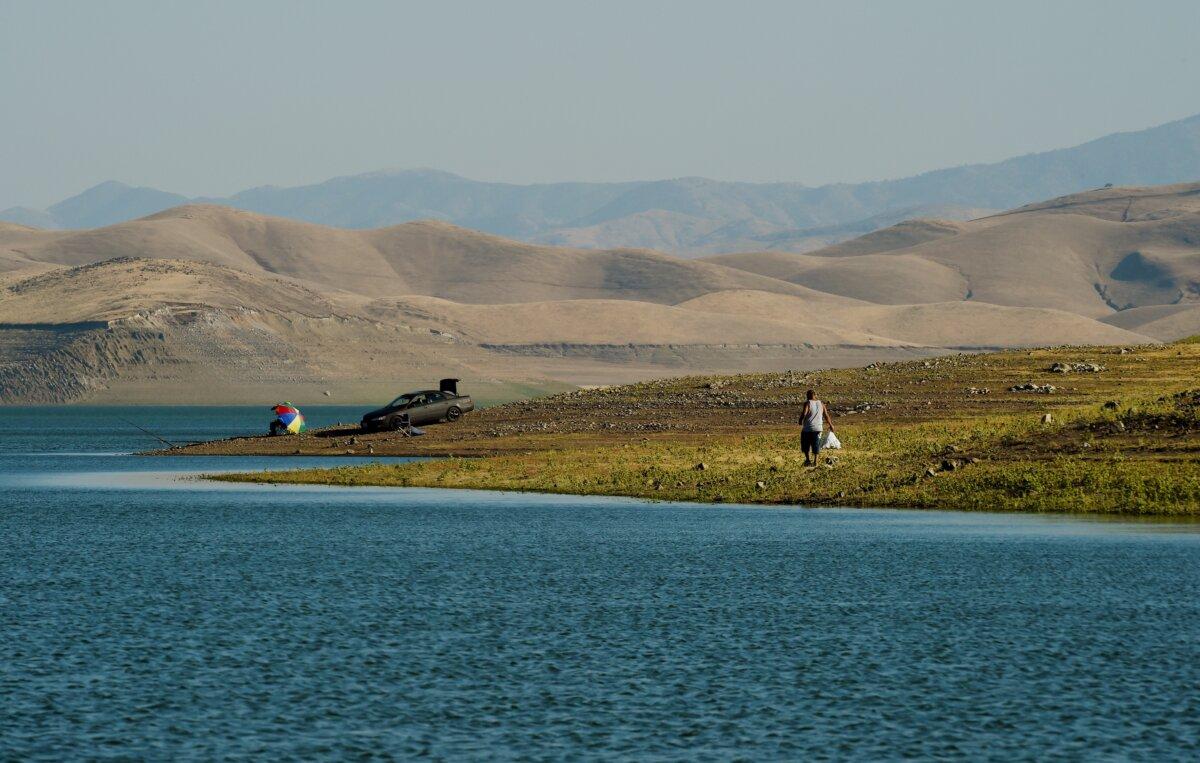 People fish below the high water marks (background) of the San Luis reservoir which is at only 21 percent capacity as a severe drought continues to affect California on Sept. 23, 2014. (Mark Ralston/AFP via Getty Images)