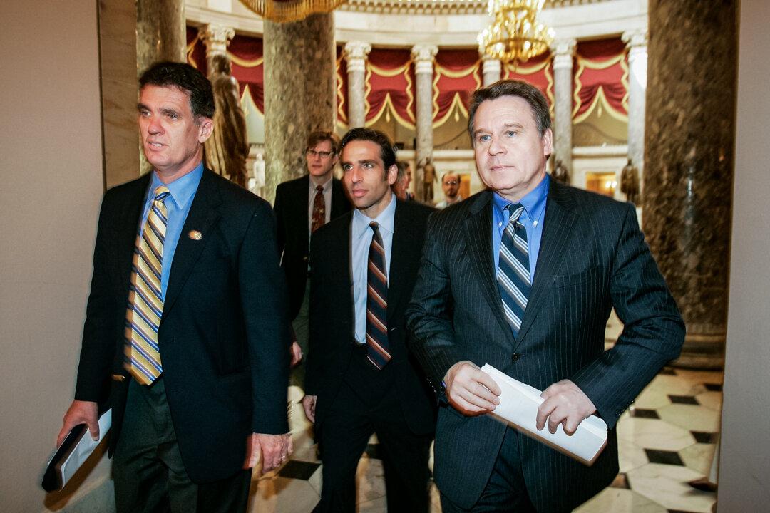 Rep. Dave Weldon (R-Fla.) (L) and Rep. Chris Smith (R-N.J.) (R) walk with brain-damaged patient Terri Schiavo's brother, Bobby Schindler (C), as they seek to restore Schiavo's feeding tube, at the U.S. Capitol on March 20, 2005. (Alex Wong/Getty Images)