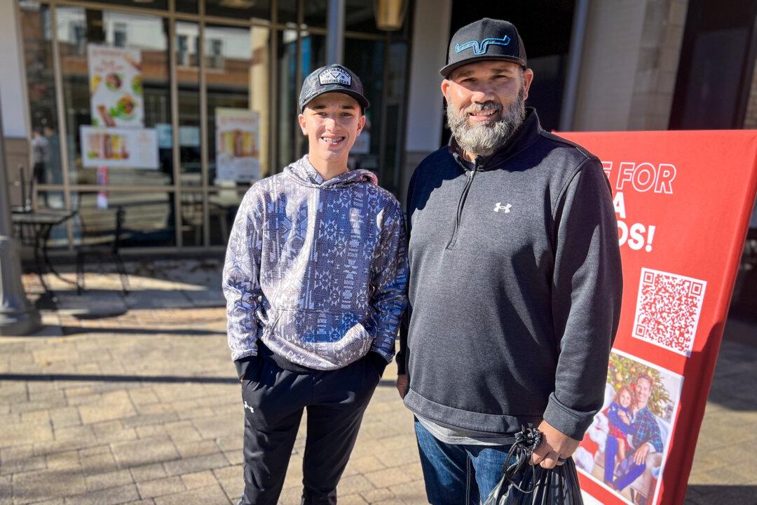 Jake Wilson (L) and his son, Kolt Wilson, of Greenfield, Indiana, at the Hamilton Town Center in Noblesville, Ind., on Nov. 26, 2024. (Lawrence Wilson/The Epoch Times)