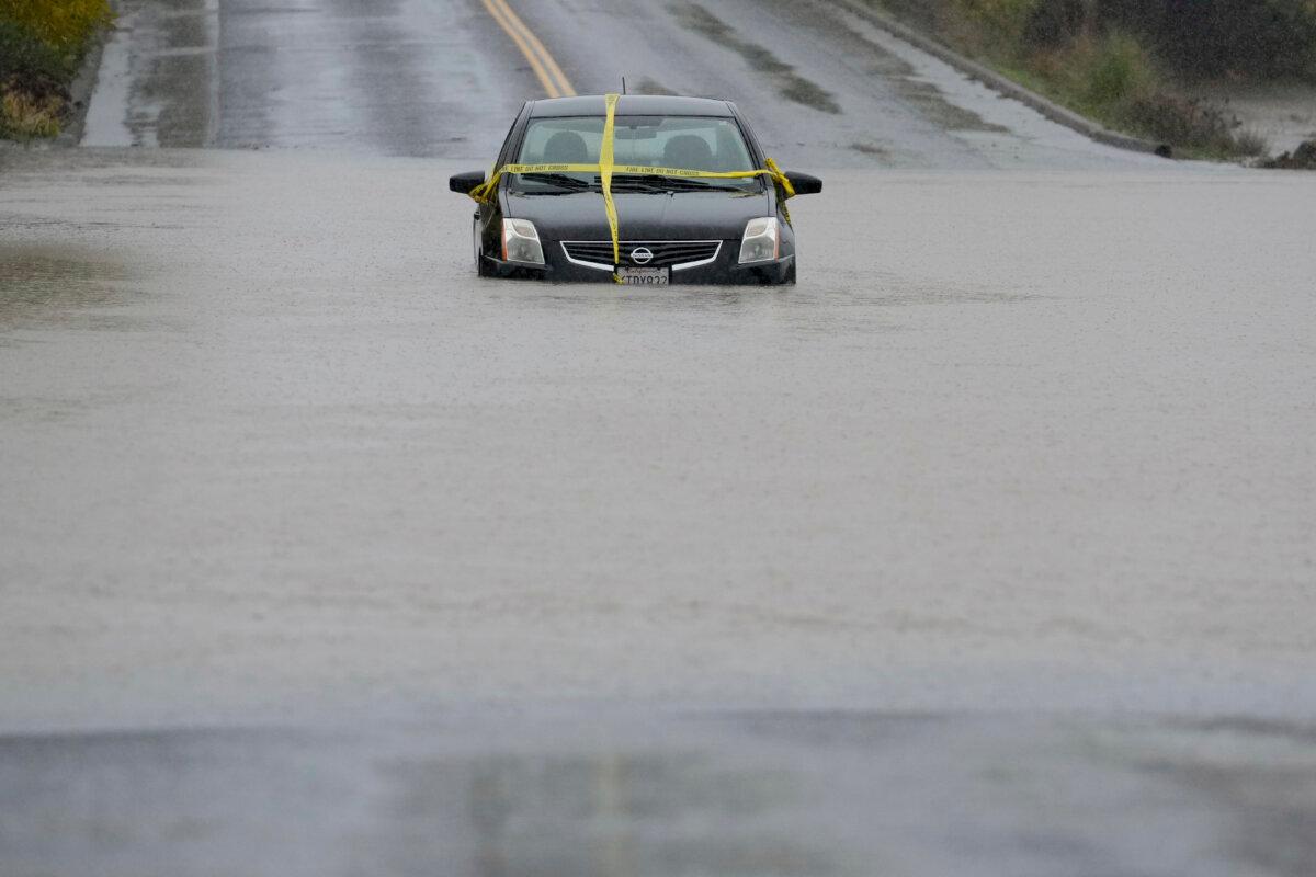 A car is left stranded on a flooded road during a storm in Windsor, Calif., on Nov. 21, 2024. (Godofredo A. Vásquez/AP Photo)