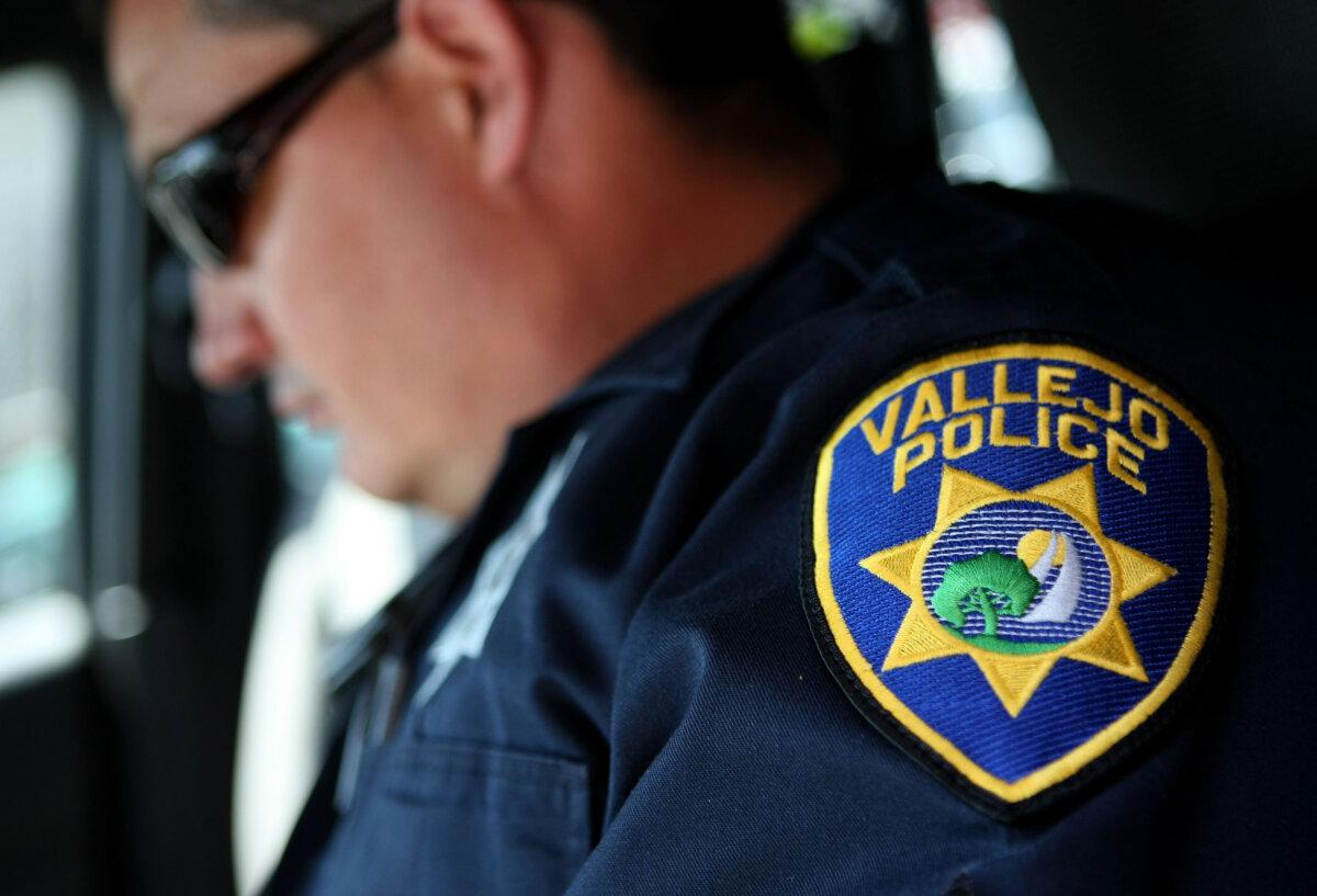 A Vallejo Police Department corporal goes over paperwork in his patrol car as he gets ready to patrol the streets in Vallejo, Calif., on May 7, 2008. (Justin Sullivan/Getty Images)