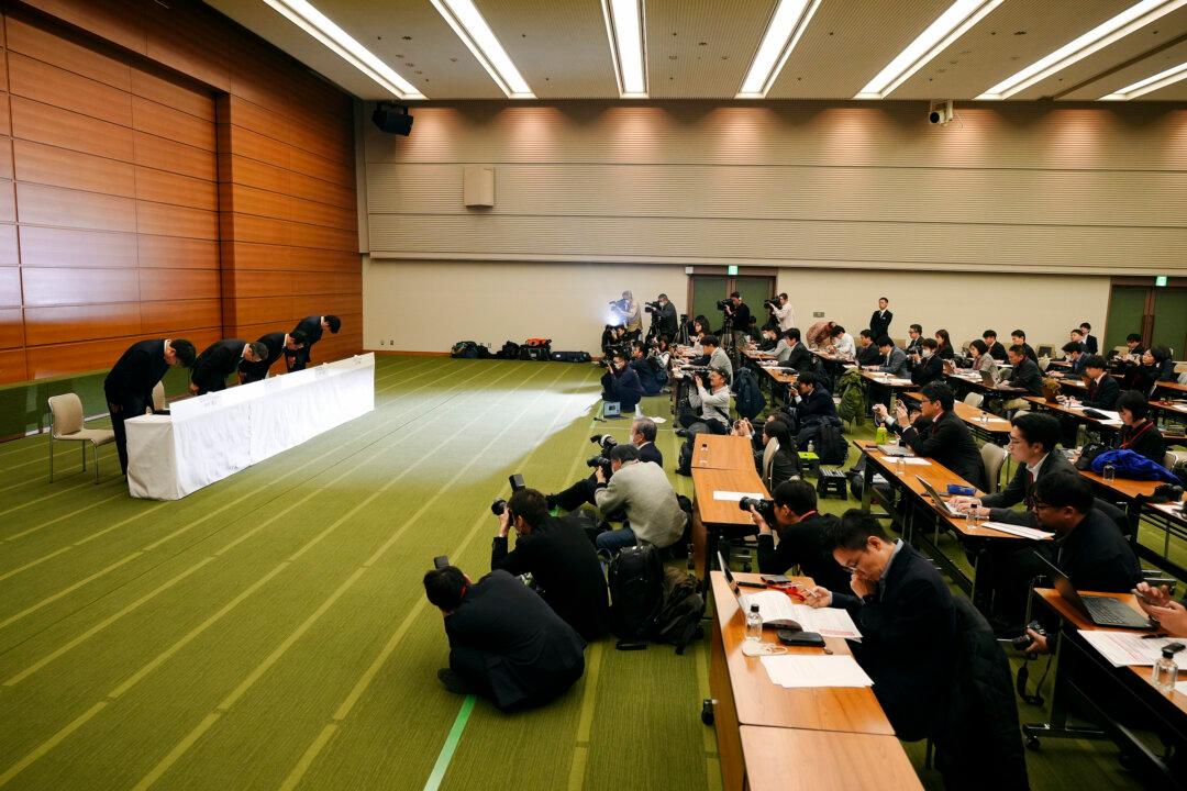 Mitsubishi UFJ Financial Group Bank President Junichi Hanzawa (2nd L) and other representatives bow during a press conference in Tokyo on Dec. 16, 2024. Japan's largest bank apologizes over the theft of millions of dollars from safe deposit boxes. (Eugene Hoshiko/AP Photo)