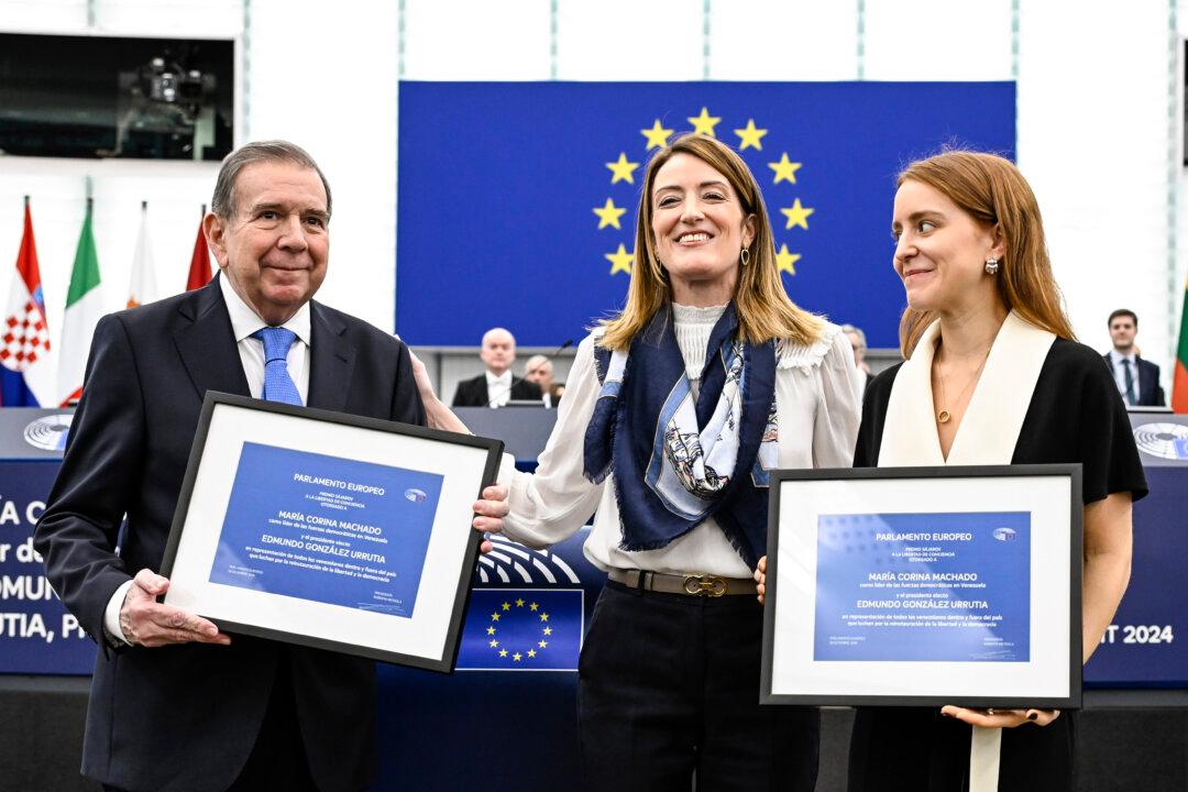 Venezuela's Edmundo Gonzalez Urrutia (left), European Parliament president Roberta Metsola (center), and Maria Corina Machado's daughter Ana Corina Sosa show the awards after Urrutia and Machado were awarded the EU's top human rights honor, the Sakharov Prize in Strasbourg, France, on Dec. 17, 2024. (Pascal Bastien/AP Photo)