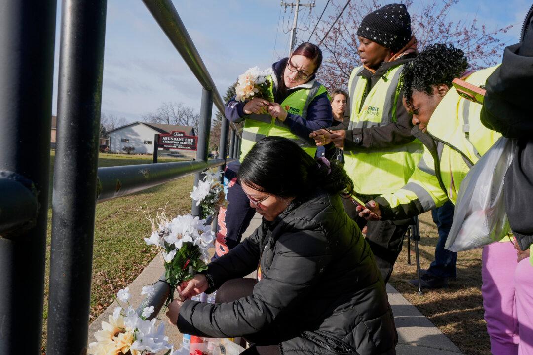 People put flowers outside the Abundant Life Christian School in Madison, Wis., on Dec. 17, 2024. (Morry Gash/AP Photo)