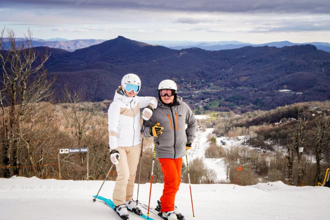 Husband and wife co-owners of Sugar Mountain Resort, Kimberley (L) and Gunther Jochl, pose at the summit, in Banner Elk, N.C., on Dec. 8, 2024. (T.J. Muscaro/The Epoch Times).