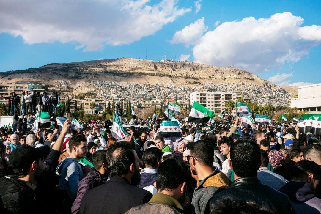 Thousands gather in the streets after the fall of the Assad regime, in Damascus, Syria. on Dec. 13, 2024. (Sami Boudra/Middle East Images/AFP via Getty Images)