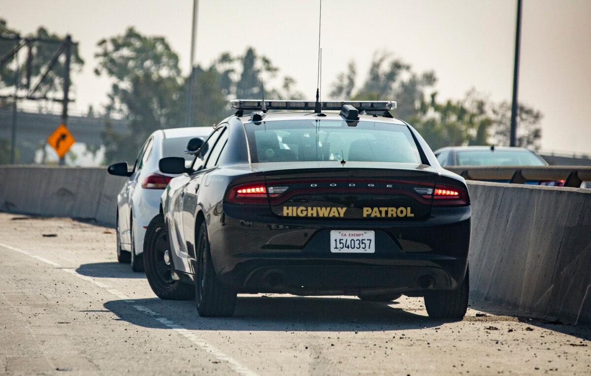 A California Highway Patrol officer pulls someone over in a file photo. (John Fredricks/The Epoch Times)