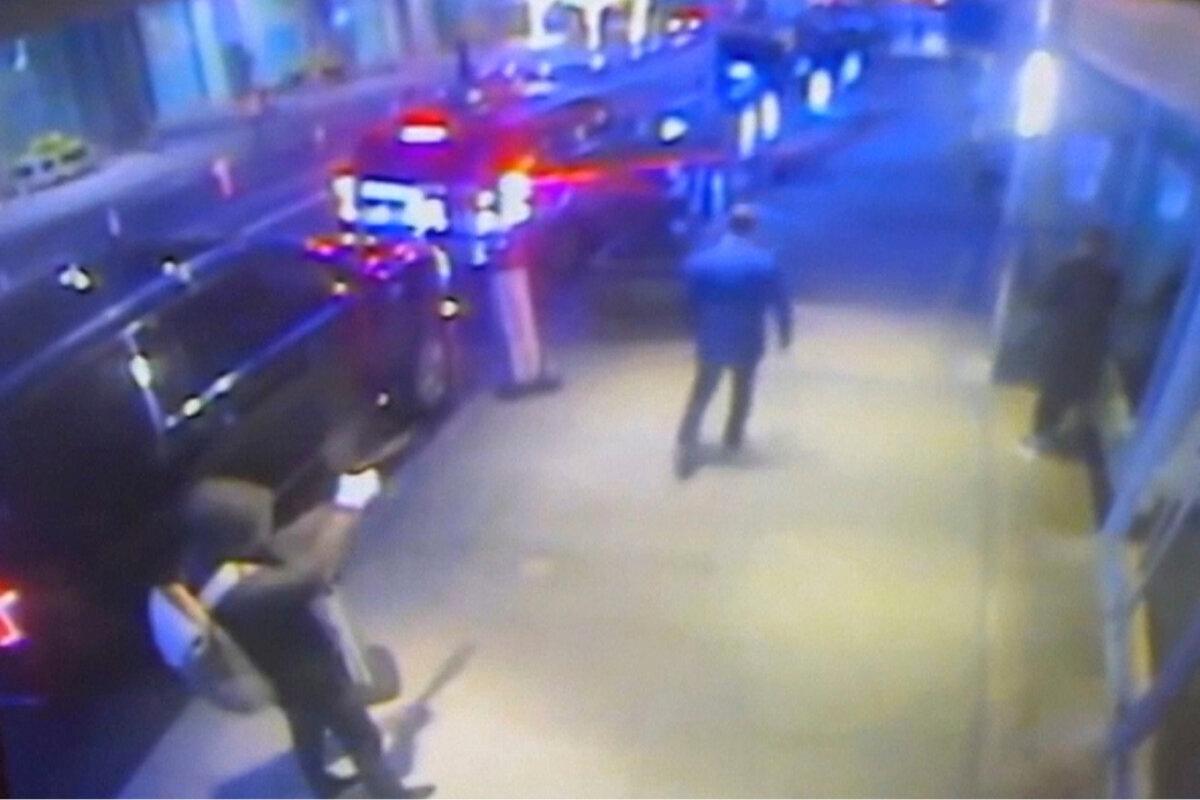 This still image from surveillance video shows the suspect, left, in the killing of UnitedHealthcare CEO Brian Thompson, center, outside a Manhattan hotel where the health insurer was holding an investor conference on Dec. 4, 2024. (AP Photo)