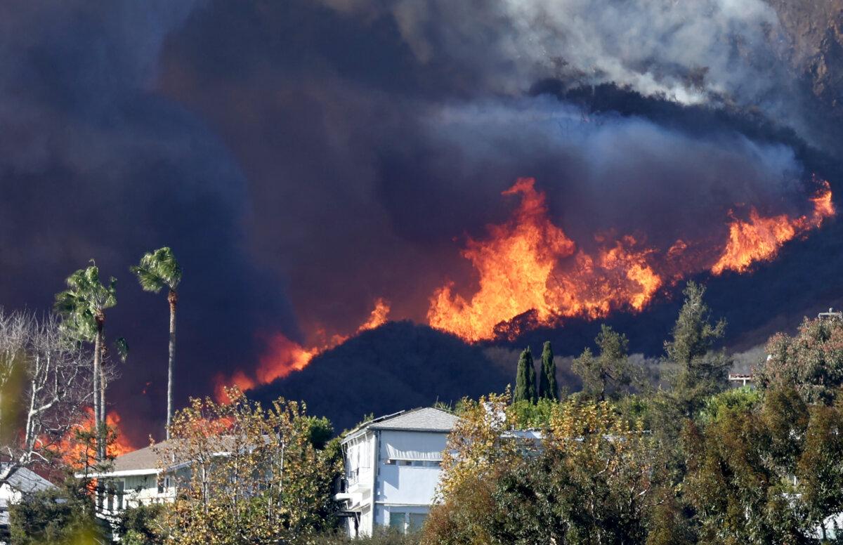 The Palisades Fire burns near homes amid a powerful windstorm in Pacific Palisades, Calif., on Jan. 7, 2025. (Mario Tama/Getty Images)