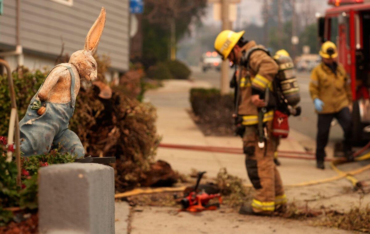 A firefighter looks at charred remains outside the destroyed Bunny Museum, in Altadena, Calif., on Jan. 9, 2025. (Chris Pizzello/AP Photo)