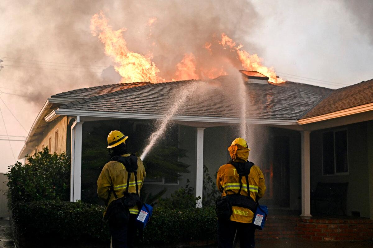 Firefighters work to put out a fire at a home during the Palisades Fire in Pacific Palisades, Calif., on Jan. 8, 2025. (Agustin Paullier/AFP via Getty Images)