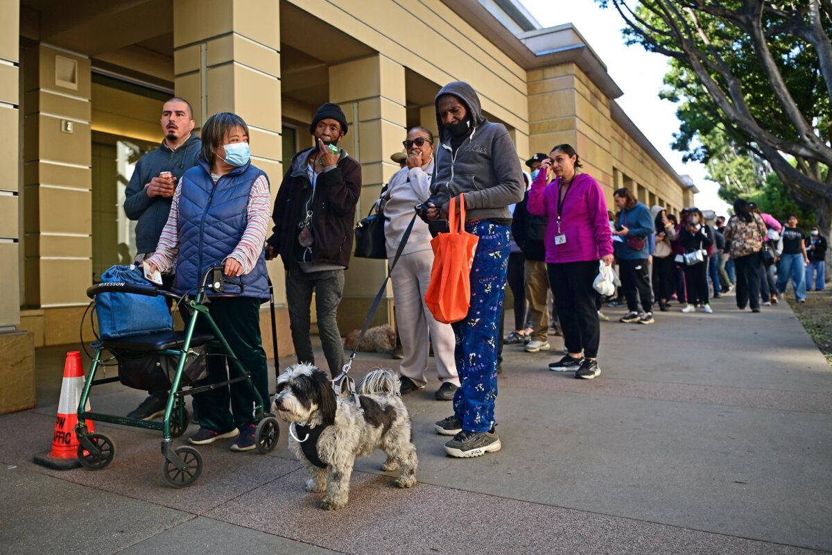 People arrive with their pets at an evacuation center in the Pasadena Convention Center in Pasadena, Calif., as they flee wildfires in the Los Angeles area on Jan. 10, 2025. (Agustin Paullier/AFP via Getty Images)