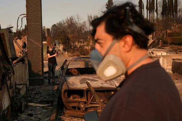 Homeowners Sohrab Nafici (R) and Christine Meinders return to their fire-ravaged neighborhood in the aftermath of the Eaton Fire in Altadena, Calif., on Jan. 10, 2025. (Jae C. Hong/AP Photo)