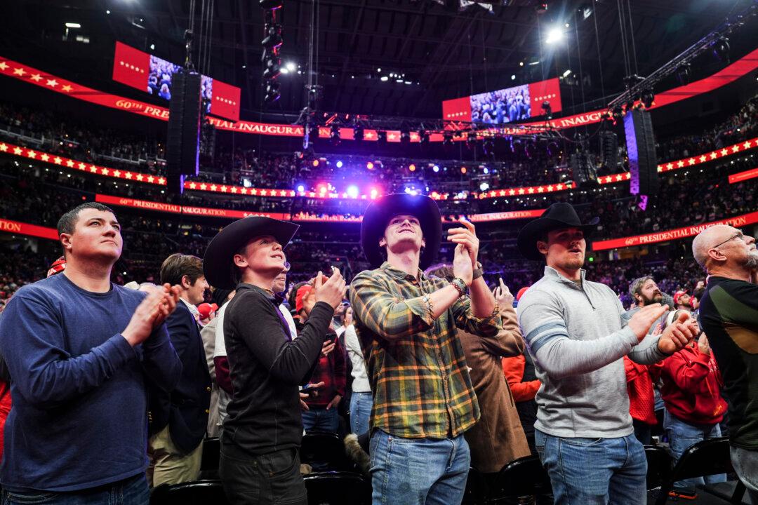 People react as they watch President Donald Trump's inauguration live from Capital One Arena in Washington on Jan. 20, 2025. (Madalina Vasiliu/The Epoch Times)