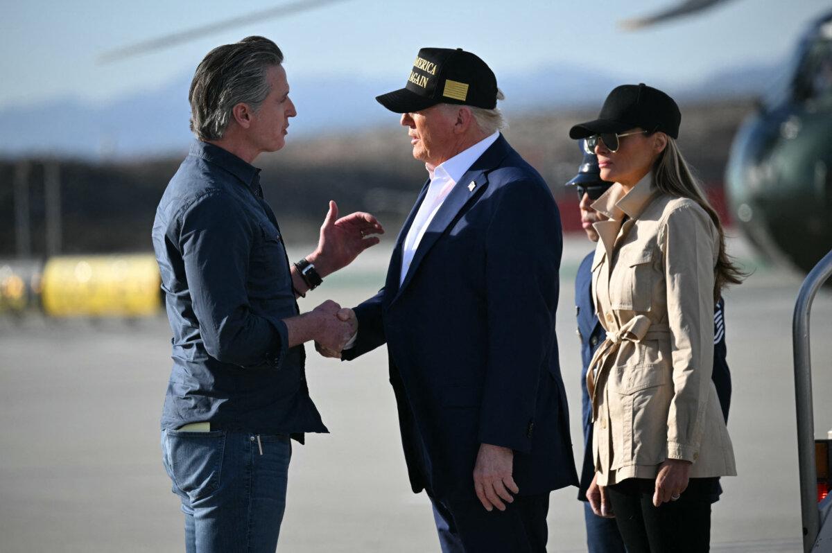 President Donald Trump followed by First Lady Melania Trump, shakes hands with California Gov. Gavin Newsom upon arrival at Los Angeles International Airport in Los Angeles on Jan. 24, 2025, to visit the region devastated by the Palisades and Eaton fires. (Mandel Ngan/AFP via Getty Images)