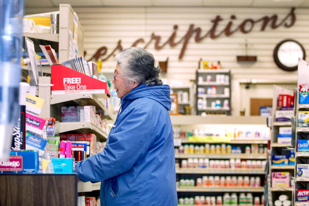 Senior citizen Yoko Mitani waits for her prescription at a pharmacy in Chicago on May 3, 2004. (Tim Boyle/Getty Images)