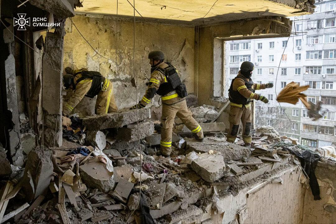 Rescuers search for civilians who were killed when a Russian drone hit an apartment building in Sumy, Ukraine, on Jan. 30, 2025. (Ukrainian Emergency Service via AP)