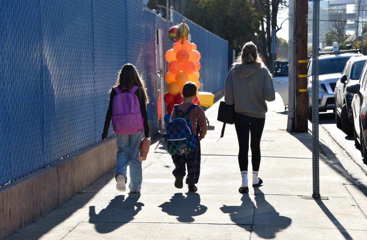 Displaced students from Marquez Elementary School, destroyed in the Pacific Palisades fire, arrive at Nora Sterry Elementary School to resume class in Los Angeles on Jan. 15, 2025. (Chris Delmas/AFP via Getty Images)