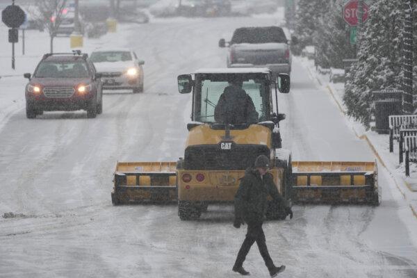 A plow clears a parking lot during a winter storm in Cincinnati, on Jan. 5, 2025. (Joshua A. Bickel/AP Photo)