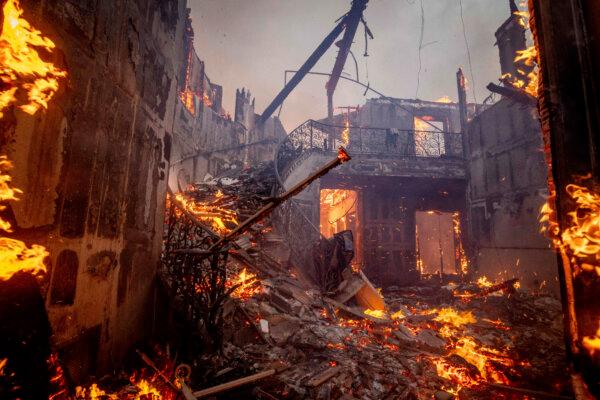 The Palisades Fire burns a residence in the Pacific Palisades neighborhood of Los Angeles on Jan. 7, 2025. (AP Photo/Ethan Swope)