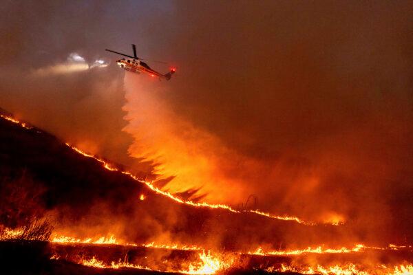 Water is dropped by helicopter on the Kenneth Fire in the West Hills section of Los Angeles on Jan. 9, 2025. (Ethan Swope/AP Photo)