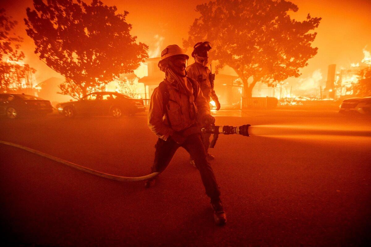 Firefighters battle the Palisades Fire as it burns multiple structures in the Pacific Palisades neighborhood of Los Angeles on Jan. 7, 2025. (Ethan Swope/AP Photo)