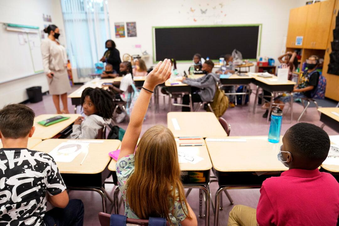 A student raises her hand during class at Tussahaw Elementary School in McDonough, Ga., on Aug. 4, 2021. (Brynn Anderson, File/AP Photo)