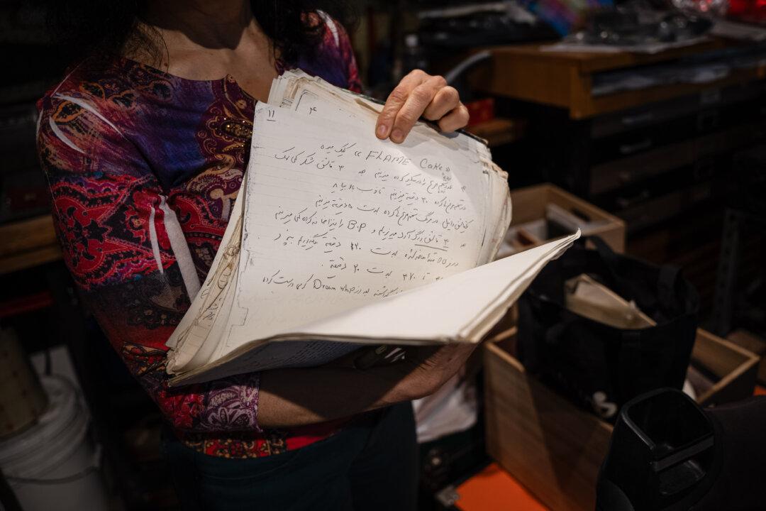 (Top) Anita Ghazarian and Simon Penny are staying with friends in the Glassell Park neighborhood of Los Angeles, on Feb. 1, 2025. (Bottom) When they evacuated, Ghazarian grabbed her mother's cookbook (Left), handwritten in Farsi, and Penny grabbed his mothers diary (Right). (Beige Luciano-Adams/The Epoch Times)